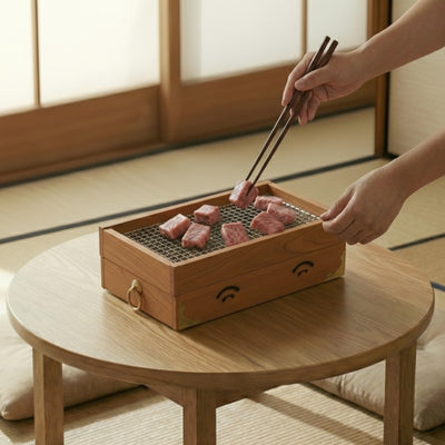 Traditional bbq grill japanese wood with wagyu beef pieces cooked using chopsticks in authentic tatami room