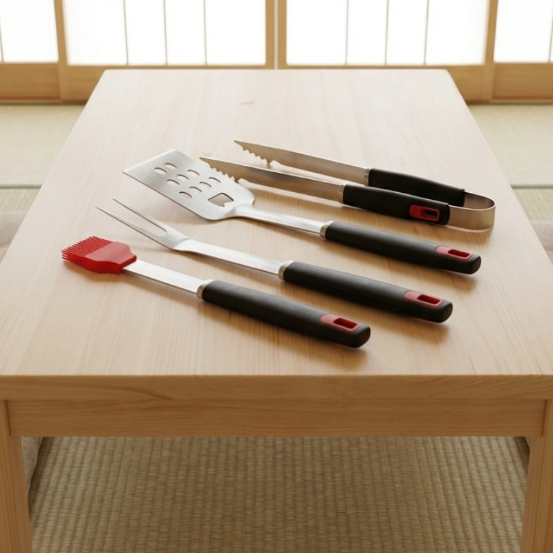 Four-piece bbq tool set with stainless steel spatula tongs fork and silicone basting brush on low chabudai table in Japanese tatami room with shoji screens