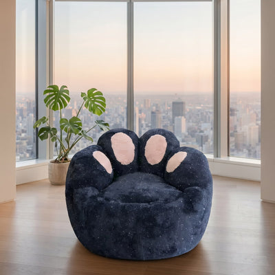 Navy blue kids bean bag chair with a soft paw-shaped design and pink cushions, displayed in a modern apartment with panoramic city views.