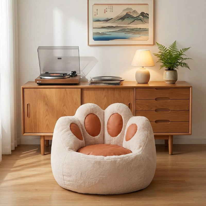 Cute bean bag cat paw chair in beige fleece near vintage wooden credenza with record player and Japanese wall art