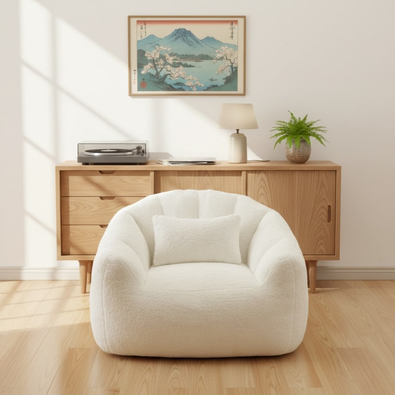 Bean bag japanese in white teddy fabric beneath Mount Fuji vintage print and mid-century credenza with turntable and fern