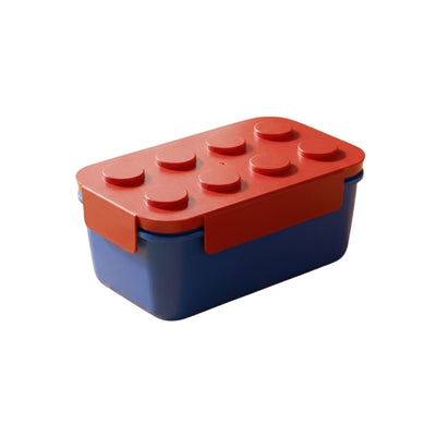 Red lid bento big box japanese with navy blue container and raised stud pattern on neutral white background