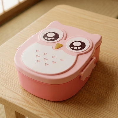 Adorable pink bento box for kids with owl face compartments and secure side clips on wooden surface