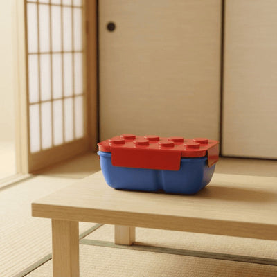 Building block inspired bento box japanese lego style displayed on low wooden table with tatami floor near sliding door in natural light
