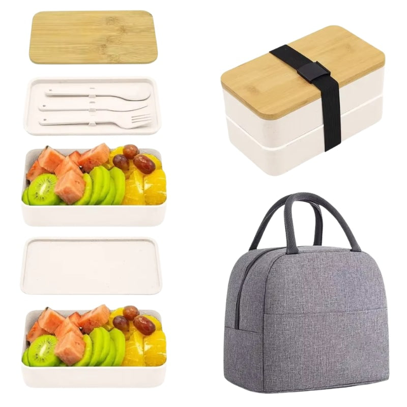White bento box japanese lunches with bamboo top displaying two-tier design filled with colorful fresh fruit and white utensils beside gray insulated lunch bag