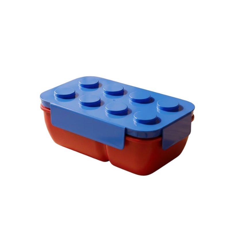 Colorful blue and red bento snack box japanese design with raised Lego studs on neutral white background