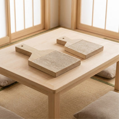 Traditional big and small wasabi grinder set in natural wood displayed on chabudai low table