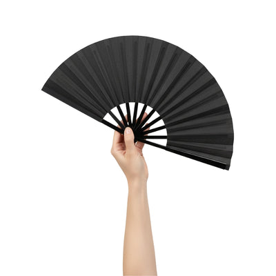 Classic big japanese fan black held gracefully in hand against neutral backdrop highlighting matte finish and traditional structure