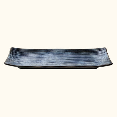 Contemporary blue plate of sushi with horizontal stripe texture in dark indigo ceramic finish