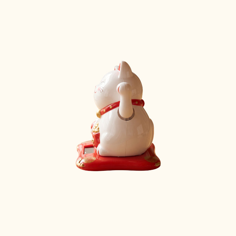 White Cat Japanese Maneki Neko figurine, side view with raised paw, red collar and traditional Japanese design