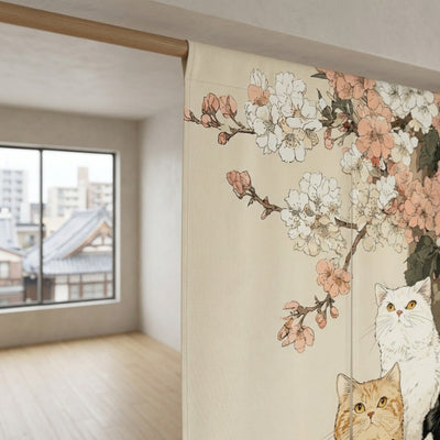 Close-up of cat japanese noren with three cats and pink cherry blossom branches hanging on wooden rod in bright modern Japanese apartment with city rooftop view