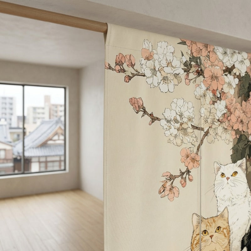 Close-up of cat japanese noren with three cats and pink cherry blossom branches hanging on wooden rod in bright modern Japanese apartment with city rooftop view