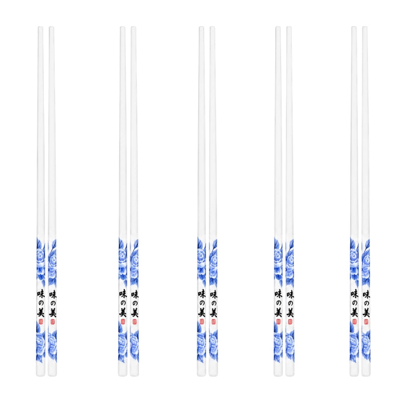 Set of 5 pairs of ceramic chopsticks in white with blue peony flowers and Asian calligraphy decoration, displayed on white background