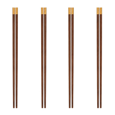 Four pairs of wood chopsticks with gold tips displayed vertically on white background