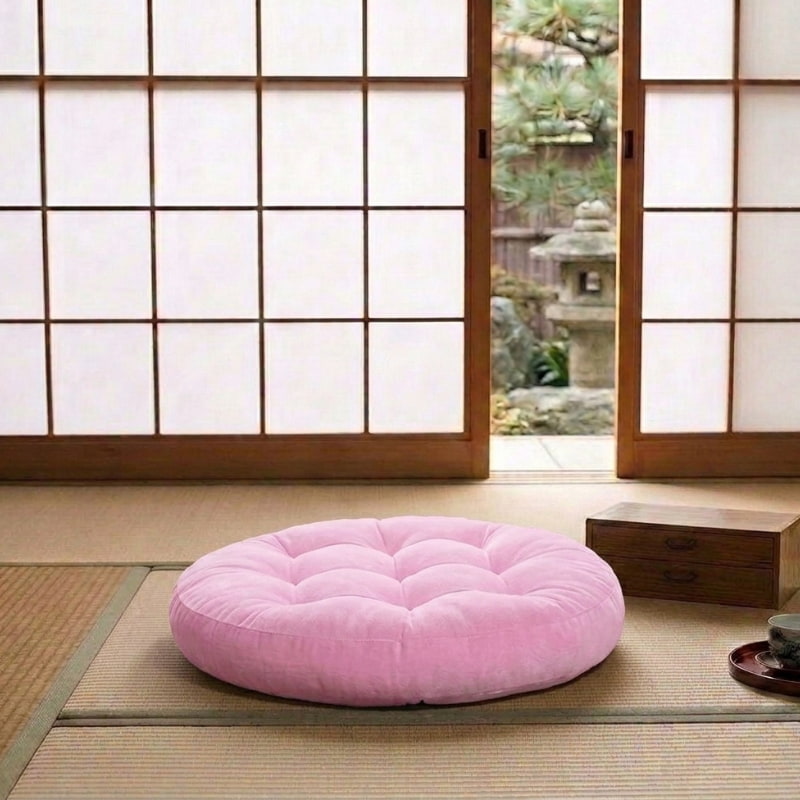 This velvet pink cushion, part of a cushions Japanese floor set, rests on tatami near a shoji screen door