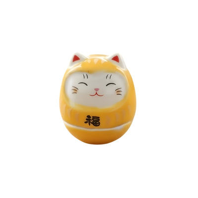 Yellow daruma lucky cat japanese with smiling white face red ear details and fortune kanji on clean background