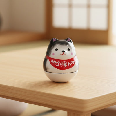 Calm daruma shiba with red protection scarf on wooden table in traditional tatami room with natural light