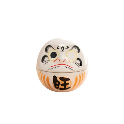 Round daruma white japan featuring traditional fierce expression and orange prosperity symbols on clean white background