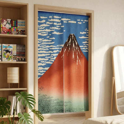 Doorway noren curtain volcano Red Fuji Hokusai design hanging in modern bedroom with manga bookshelf and monstera plant