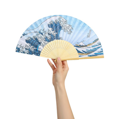 Classic fan hand kanagawa featuring iconic great wave pattern with Mount Fuji held gracefully against white backdrop showcasing blue ocean details