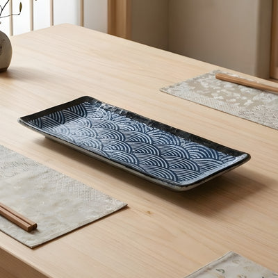 Sophisticated fancy sushi plate featuring traditional seigaiha wave motifs in indigo blue ceramic glaze