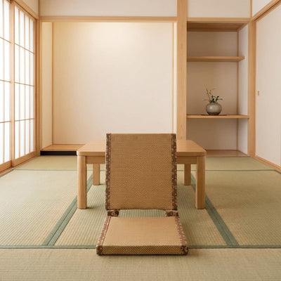 Floor chair tatami with brown embroidered border facing wooden table in traditional room with tatami and shoji screen