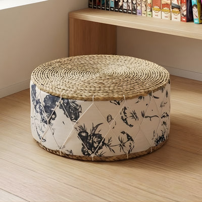 Floor cushion japanese with natural rattan weave and white fabric with navy botanical prints near manga collection shelf