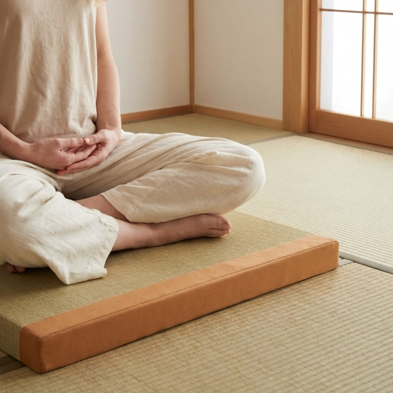 Floor cushion orange japanese with person in white clothing sitting seiza position on tatami mat with shoji screen backdrop