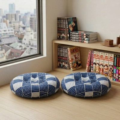 With matching wave patchwork in blue, this Japanese cushion pair rests on the floor near a manga bookshelf