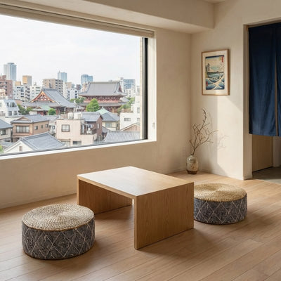 Floor japanese seating arrangement with geometric pattern cushions and chabudai table near window with temple view and ukiyo-e art