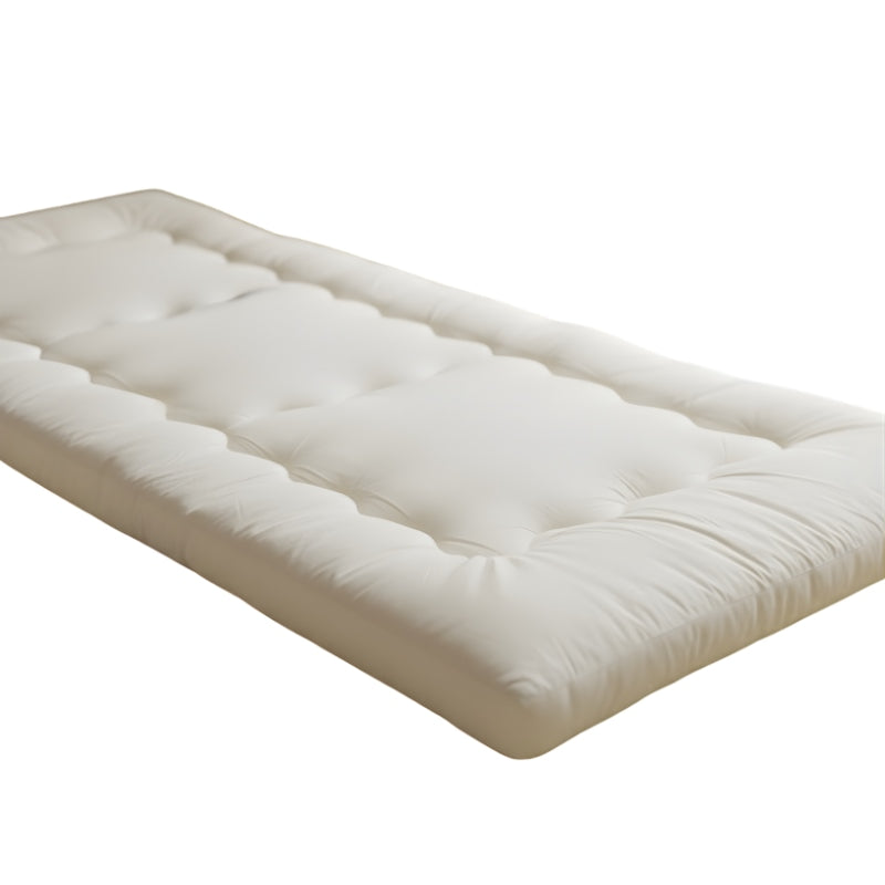 Thick quilted futon japanese traditional with white cotton surface and visible stitching patterns on neutral background