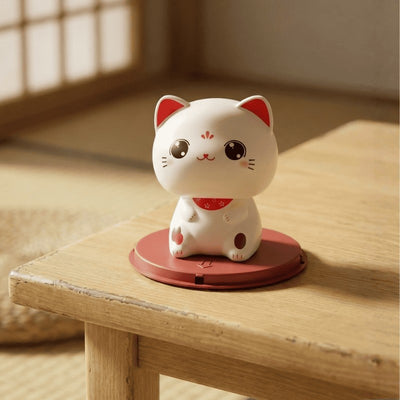 Alert good luck cat maneki neko with wide open eyes positioned on wooden surface in traditional Japanese interior with natural lighting