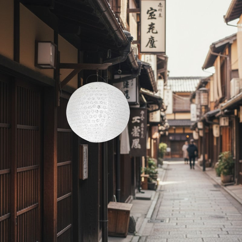 White spherical hanging lantern japanese suspended outside traditional wooden storefront on historic district street in daylight