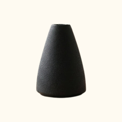 Black textured ceramic ikebana arrangement flower vase with cone shape on clean white background