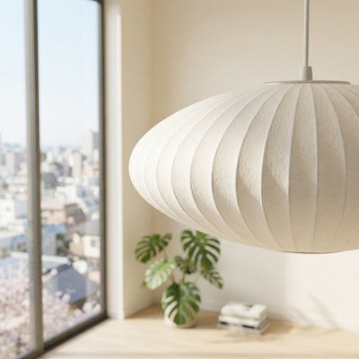 Round japandi lamp white pendant with vertical pleated texture hanging in modern apartment with city view