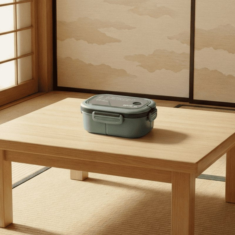 Refined japanese adult bento box in sage green displayed on natural wood table with wabi-sabi aesthetic and mountain art backdrop