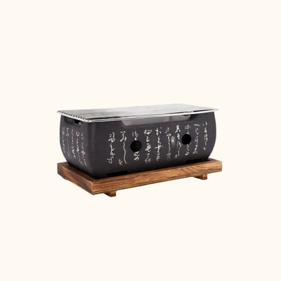 Japanese barbecue grill black finish with traditional calligraphy engraving, metal grilling grate and wooden base for authentic yakiniku experience