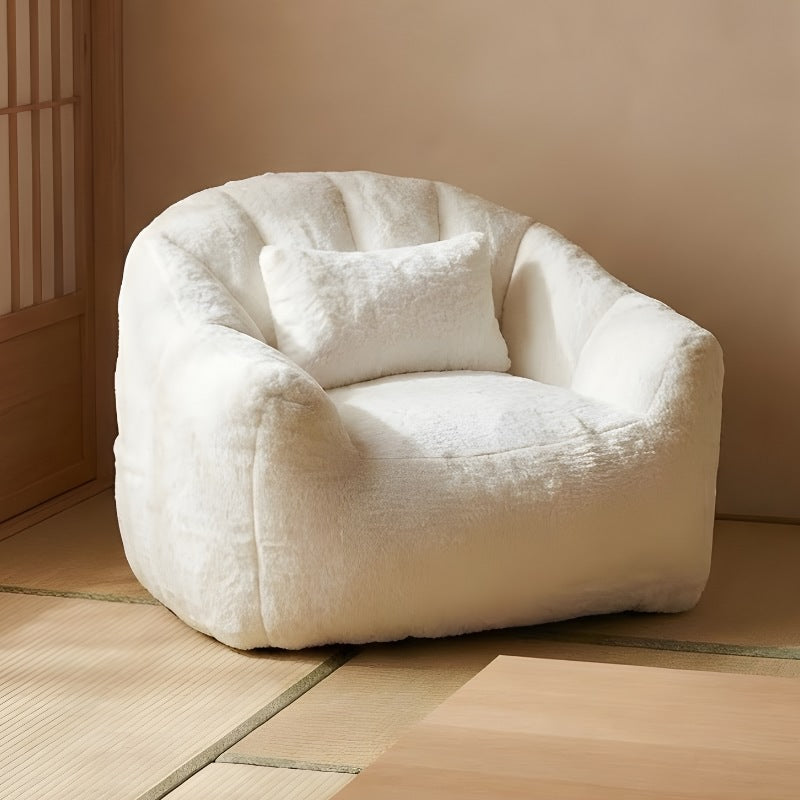 Japanese bean bag with cream teddy texture and lumbar pillow on tatami floor near wooden slatted partition wall