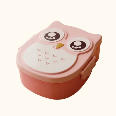 Pink owl shaped Japanese bento box for kids with large eyes and yellow beak on clean white background