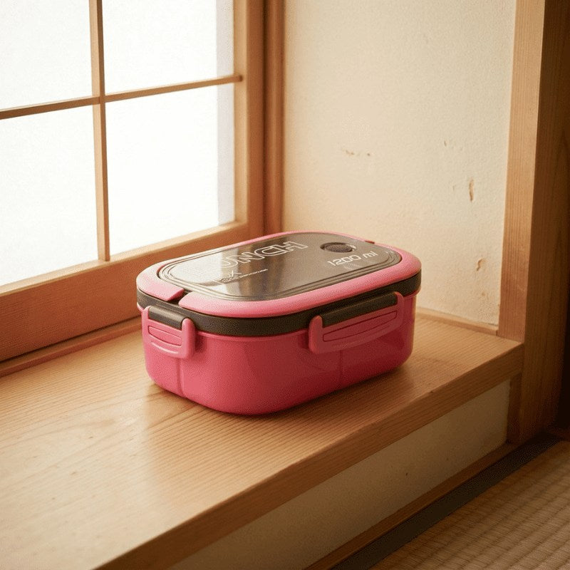 Vibrant pink japanese bento box lunch box with window lid placed on wooden windowsill beside traditional shoji screen catching warm natural light