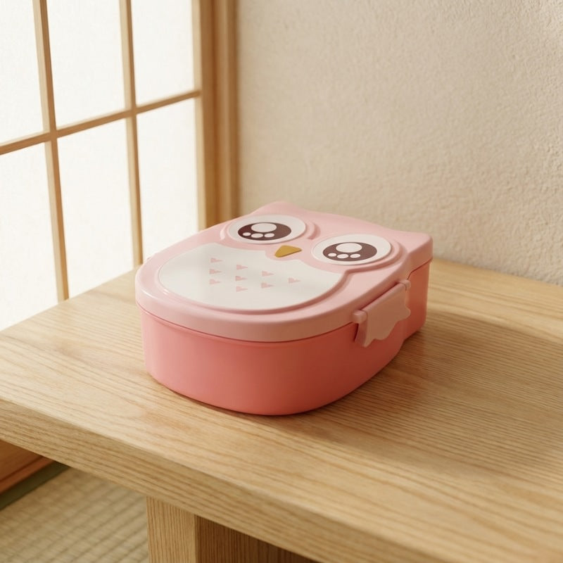 Compact japanese bento box meal prep featuring owl character with white belly on wooden table near shoji window