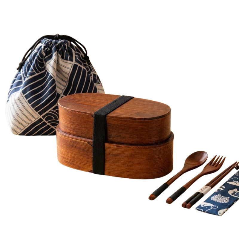 Stackable dark wood japanese traditional bento box with geometric patterned carrier bag and complete wooden utensil set on clean background
