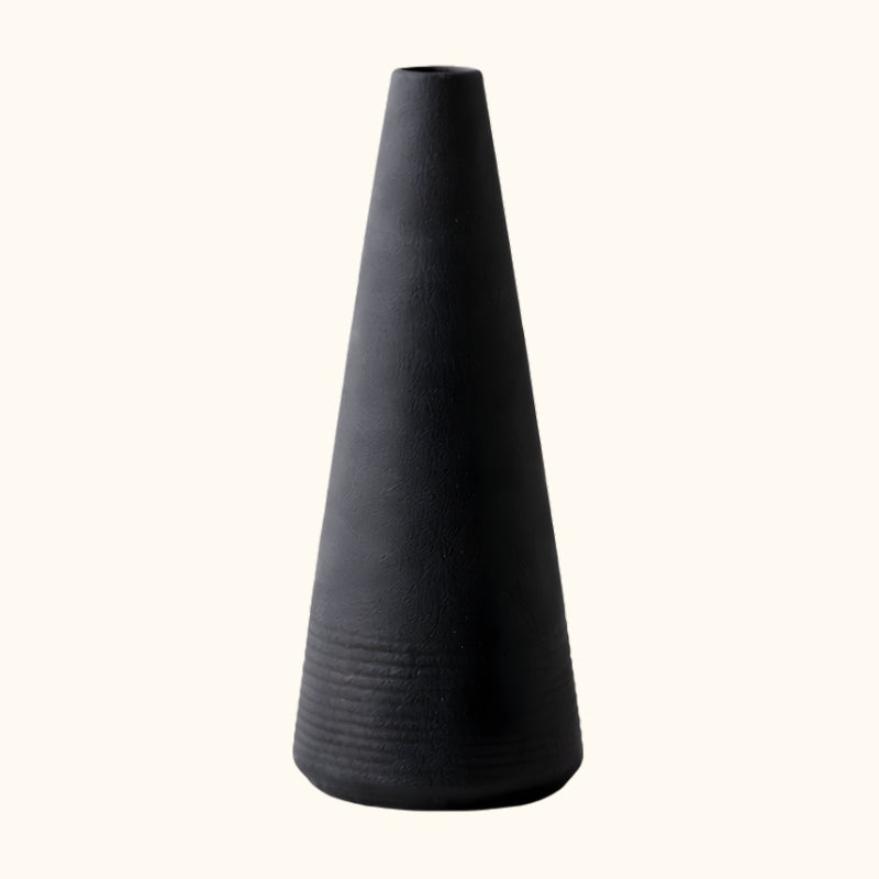 Elegant japanese black vintage vase with cone shape and ribbed texture on clean white background