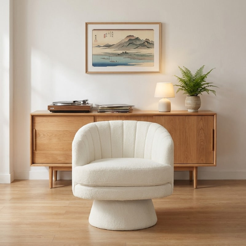 Japanese chair style with ivory upholstery and vertical channeling beneath Mount Fuji print and mid-century credenza with turntable