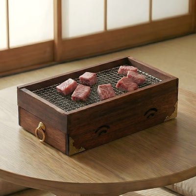 Japanese charcoal barbecue wooden box grilling premium beef cuts on mesh surface with ventilation holes and brass hardware