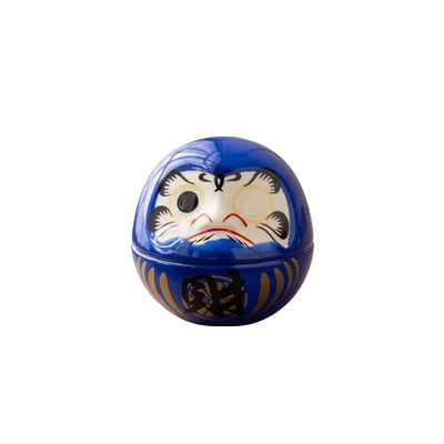 Vibrant japanese daruma blue with gold prosperity character and blank eyes for wish making on clean white background