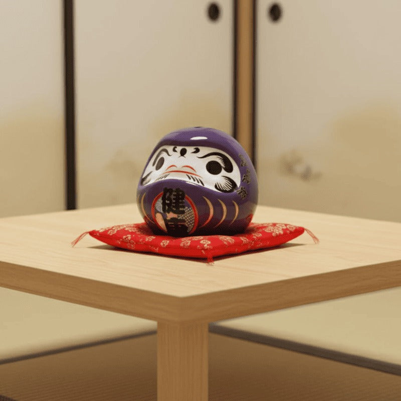 Healing japanese daruma doll purple with traditional Kanji resting on red floral cushion atop wooden table in serene minimalist interior