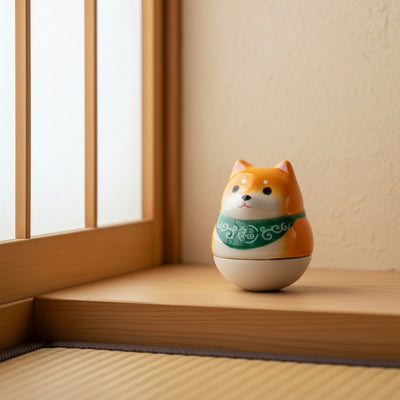 Vibrant japanese daruma doll shiba in orange with green collar near shoji screen on wooden surface