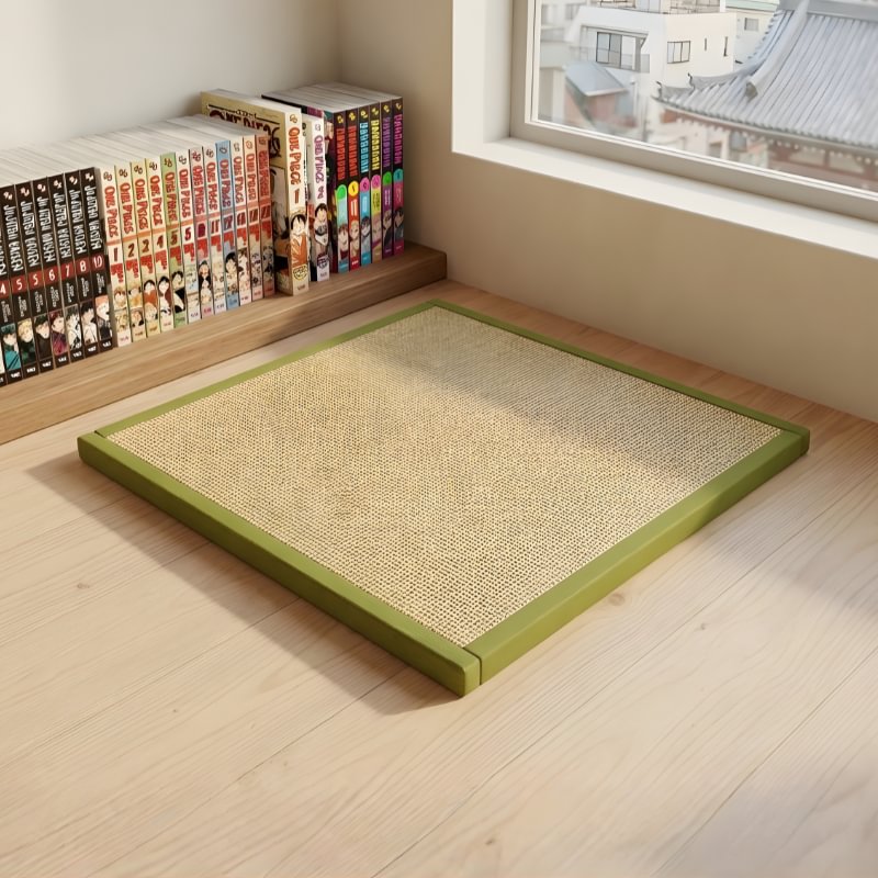 Japanese floor mat in green bordered rattan weave near window with urban view and manga bookshelf on wooden flooring