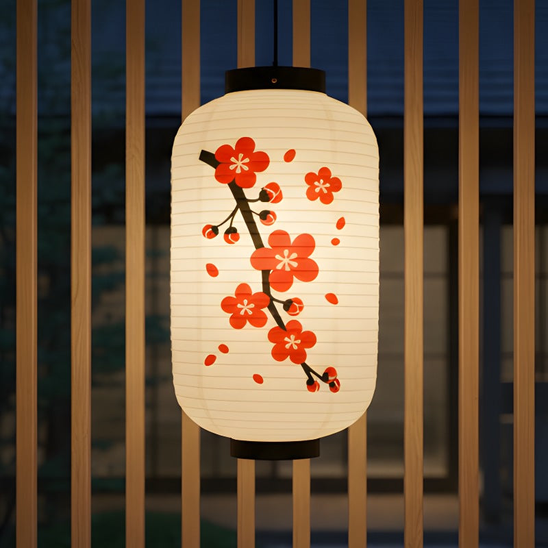 Illuminated japanese flower lantern featuring cherry blossom motif suspended near wooden railing with evening blue sky backdrop
